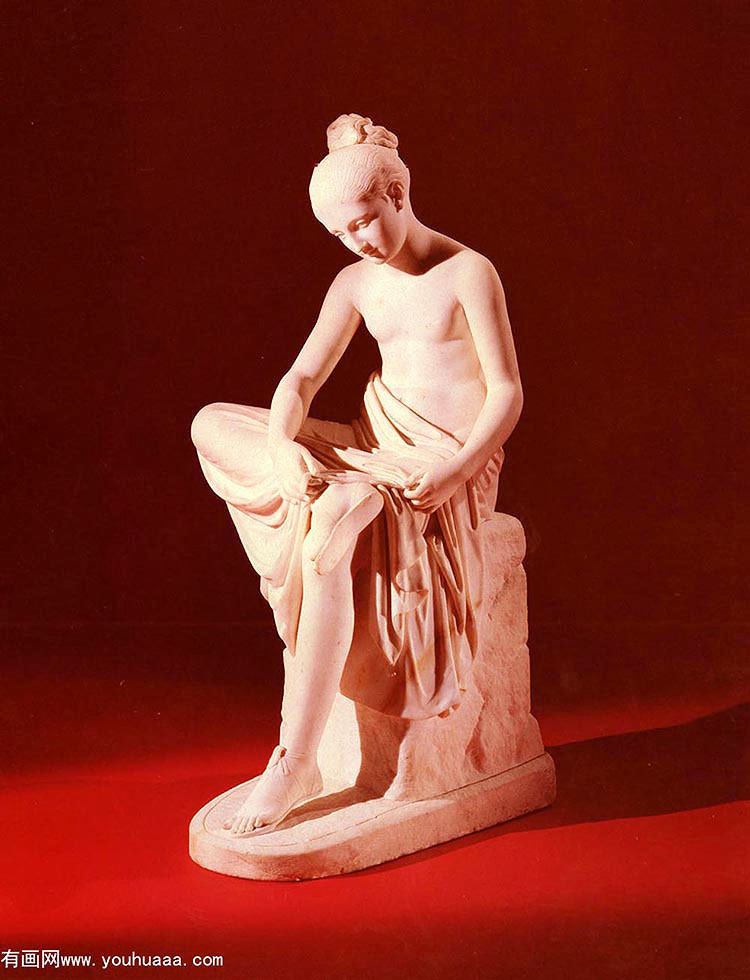 a carved white marble figure of a seated maiden