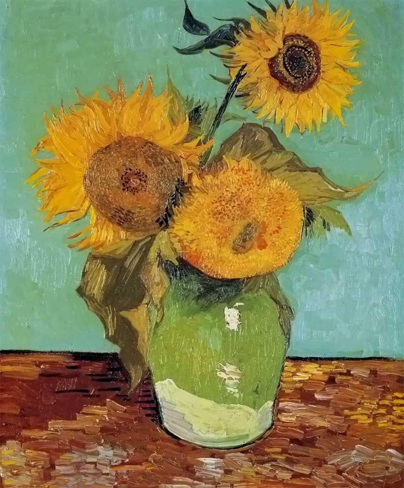 տ - three sunflowers in a vase